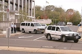 A convoy leaves the ACT City Watchhouse carrying accused murderer Russell Field