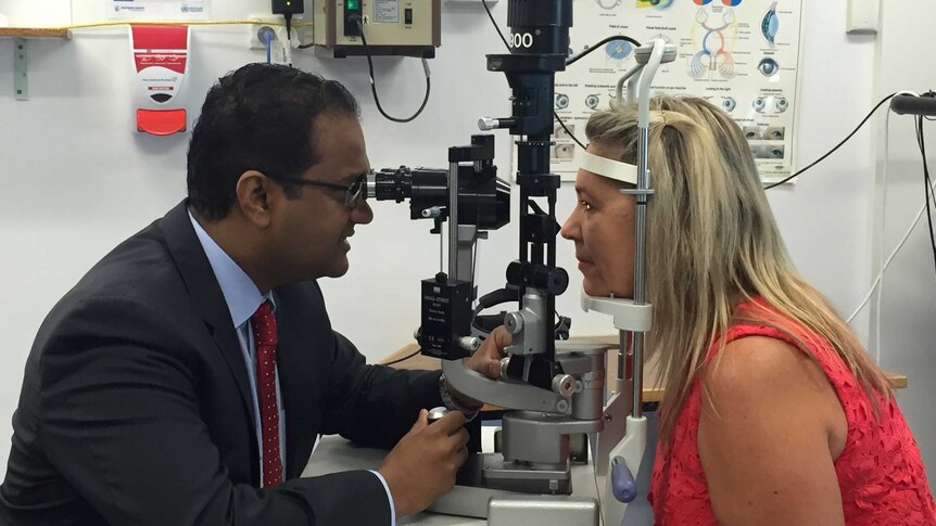 Rockhampton Hospital ophthalmologist Dr Devaraj A. Supramaniam treats a patient.