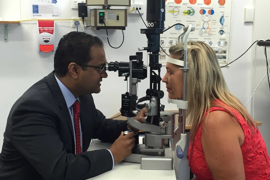 Rockhampton Hospital ophthalmologist Dr Devaraj A. Supramaniam treats a patient.