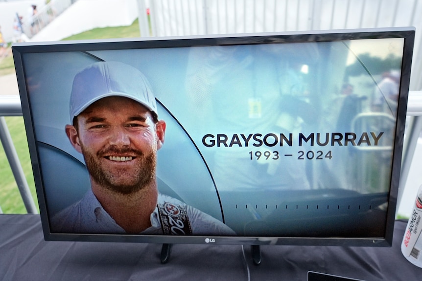 A TV shows Grayson Murray smiling