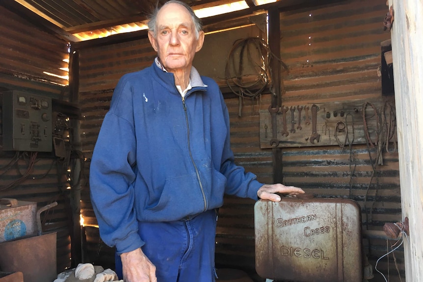 A man stands with a 32 volt power generator
