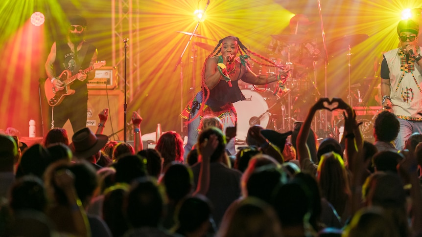 Woman on stage and crowd in front of her