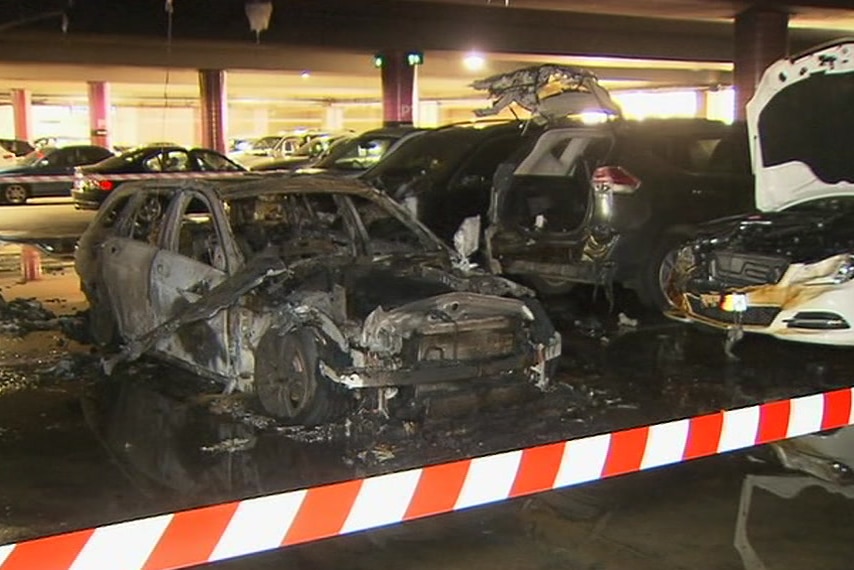 Cars showing serious fire damage.