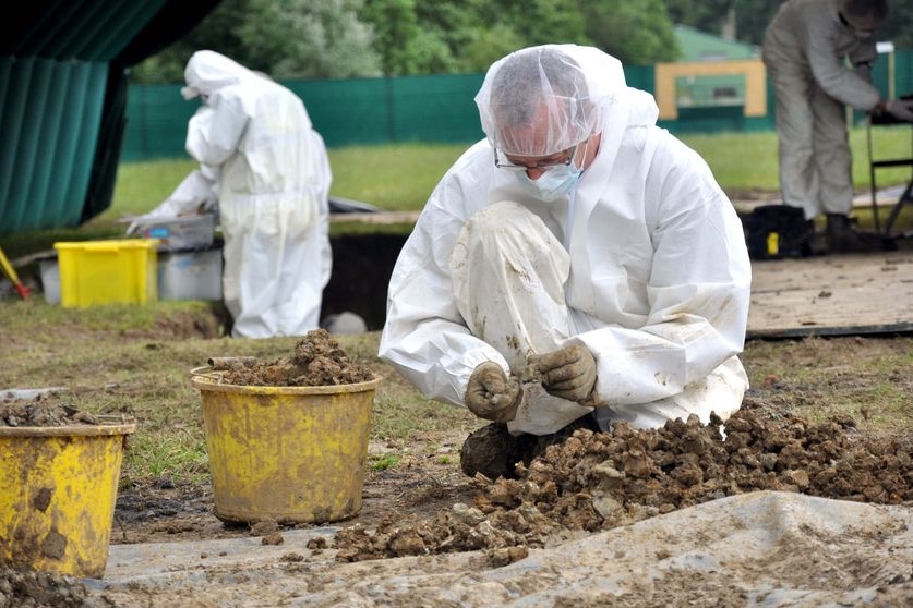 A team of archaeologists works painstakingly on a dig in the northern French town of Fromelles