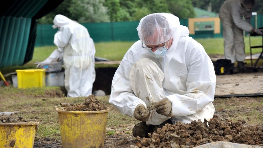 A team of archaeologists works painstakingly on a dig in the northern French town of Fromelles