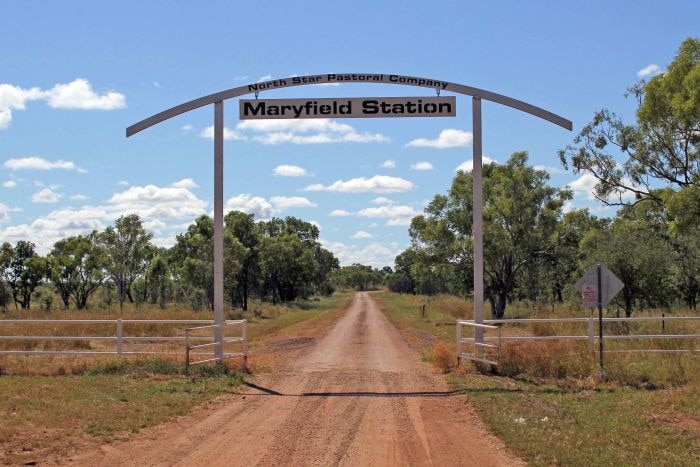 A sign saying 'Maryfield Station' over the dirt driveway at the property's front gate.