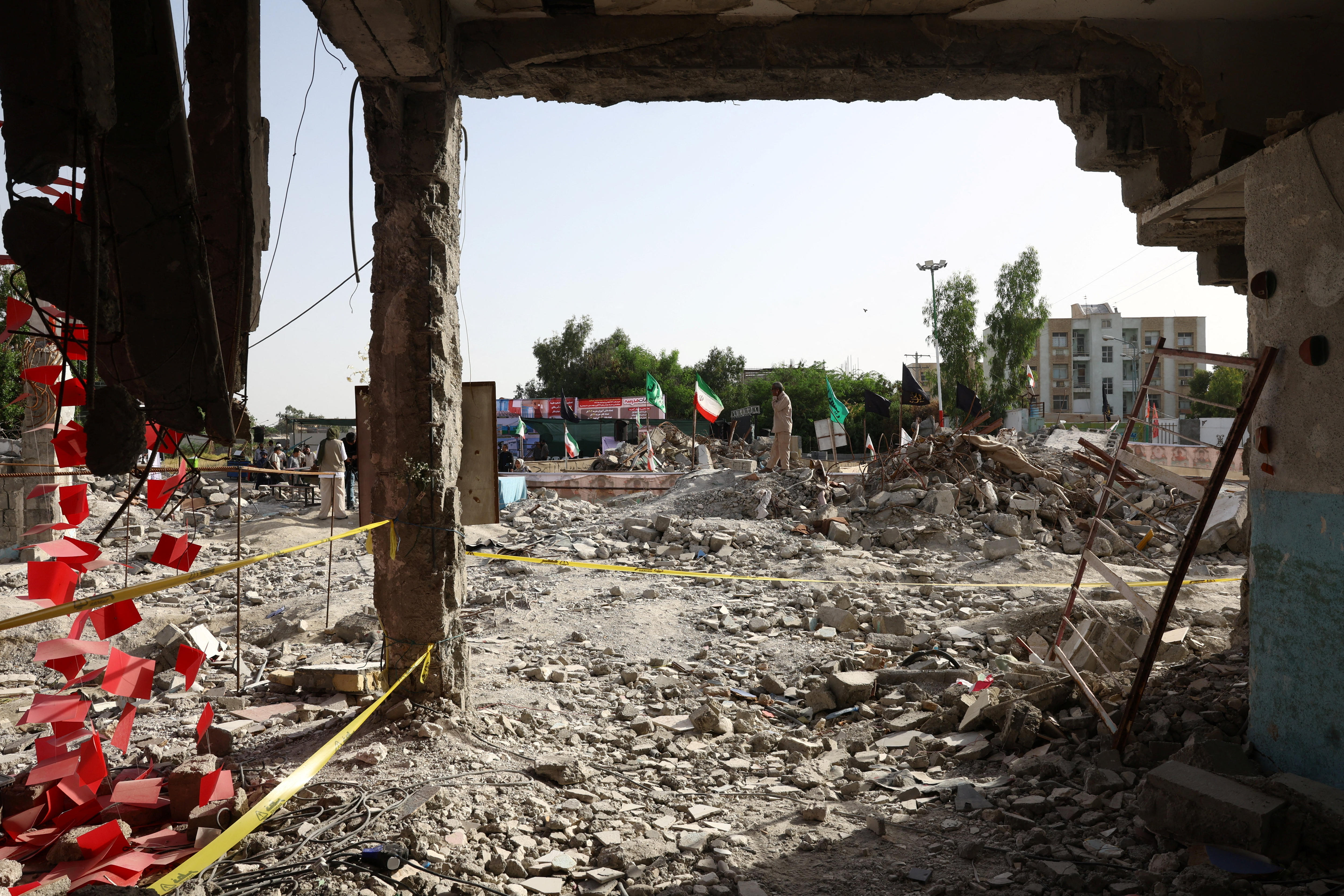 A site full of rubble and dirt following a military strike. 