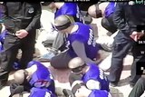 Drone footage shows hundreds of blindfolded and shackled prisoners being transferred in Xinjiang.