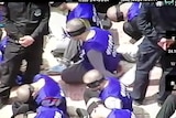 Drone footage shows hundreds of blindfolded and shackled prisoners being transferred in Xinjiang.