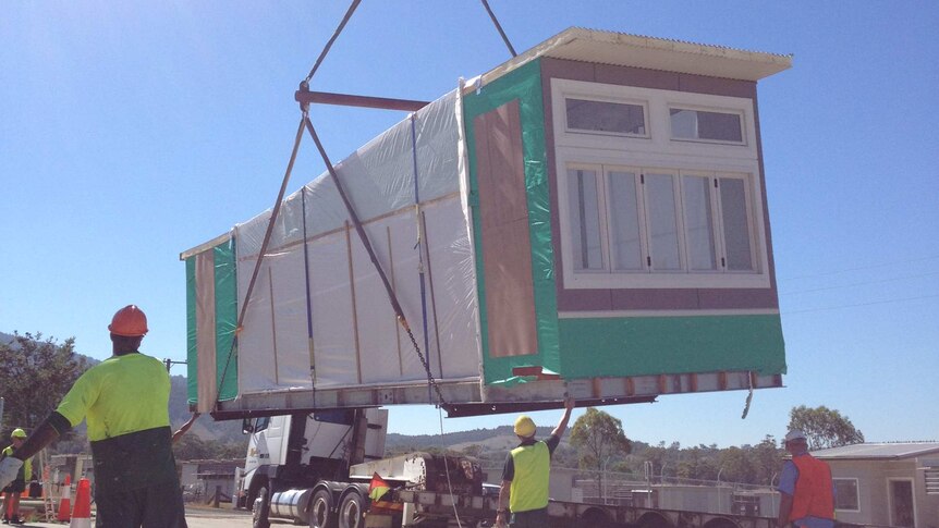 Inmates and workers at St Heliers Correctional Centre, Muswellbrook load the last of their hand made classrooms onto a truck.