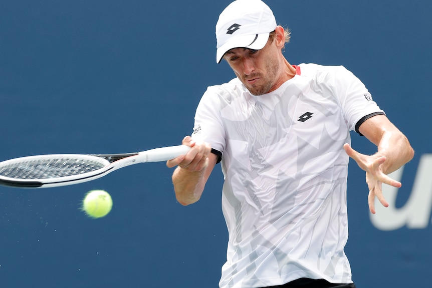 John Millman hits a slice forehand.