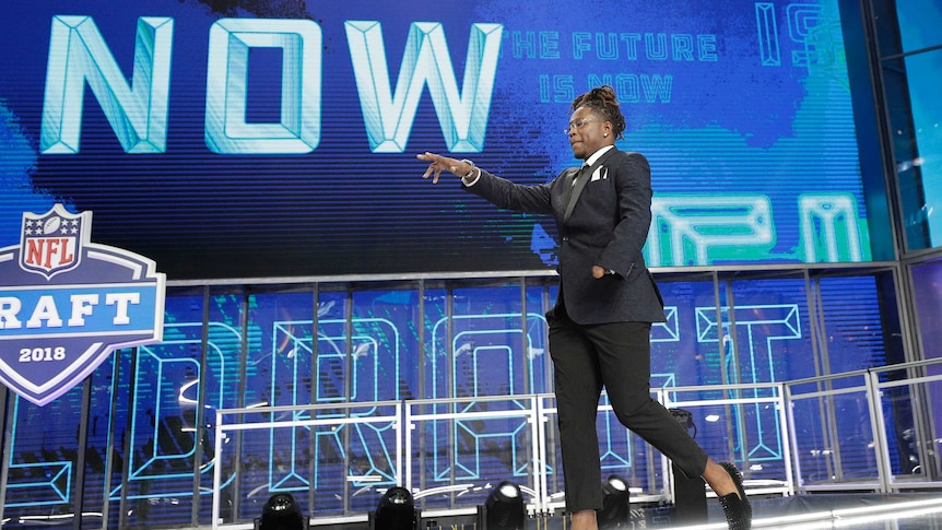 Central Florida's Shaquem Griffin walks out onto the stage at the start of the 2018 NFL Draft.