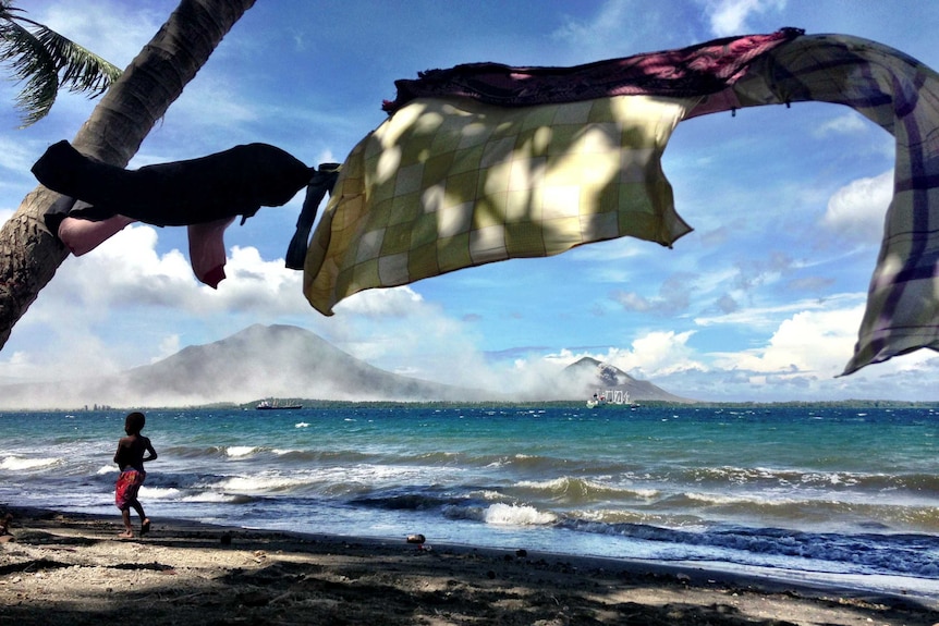 On the road to Rabaul two volatile volcanoes continue to spew ash on to the former provincial capital Rabaul.