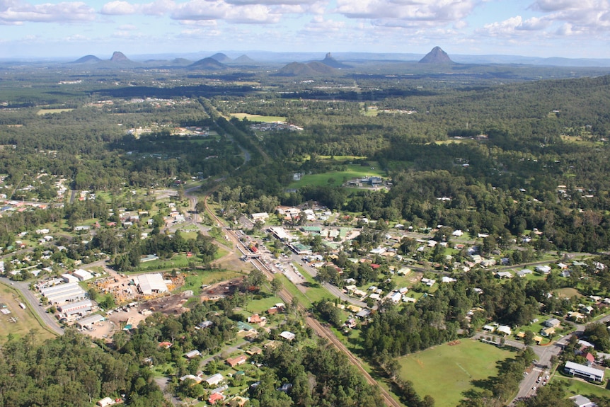 Aerial view of rural area with large mountains in the distance.
