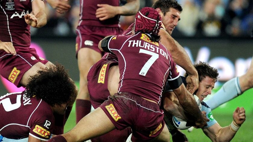 Kurt Gidley breaks through the Queensland defence to score.
