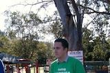 An LNP worker hands out voting information in Ryan.