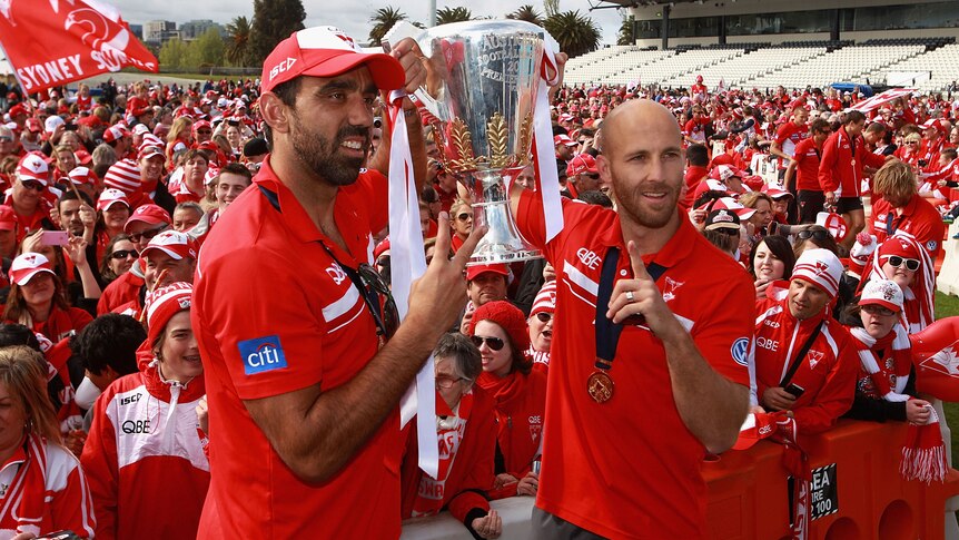Sydney co-captains Adam Goodes and Jarrad McVeigh hold up the Premiership Cup in Melbourne.