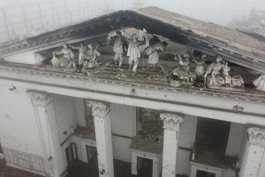 A sculptural composition depicting Soviet people of different professions decorates the destroyed Mariupol theatre.