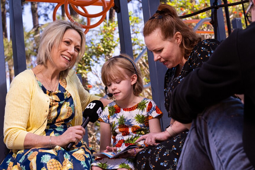Loretta Ryan, Emily Duff, and Kira Duff at a playground interview. 