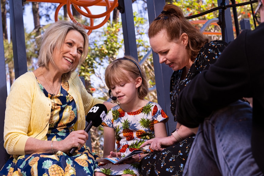 Loretta Ryan, Emily Duff, and Kira Duff at a playground interview. 