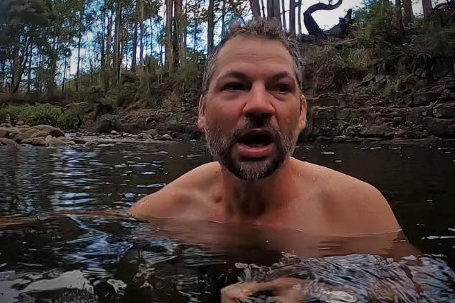 Simon Banks swimming in a Tasmanian waterway