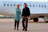 French Prime Minister Elisabeth Borne standing next to Ukrainian President Volodymyr Zelenskyy in front of a French plane.