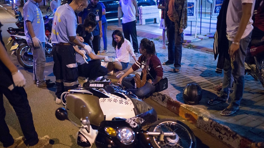 Rescue volunteers treat two women involved in a head-on motorbike collision in Vientiane, Laos.