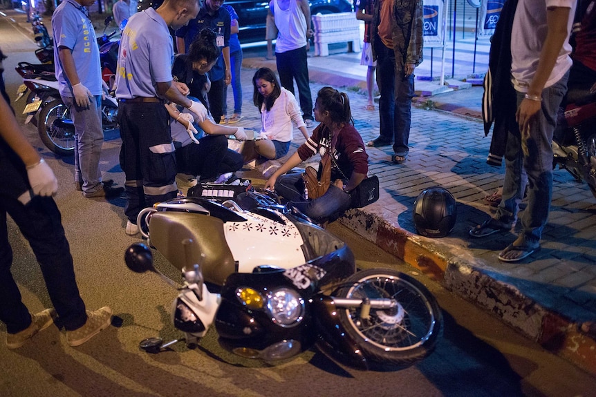 Rescue volunteers treat two women involved in a head-on motorbike collision in Vientiane, Laos.