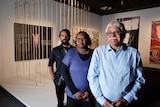 Frank Young, Anwar Young and Unrupa Rhonda Dick stand in front of their award-winning artwork.