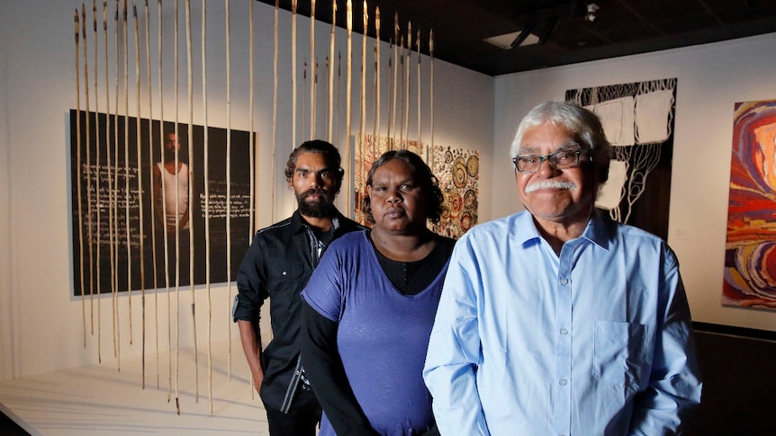 Frank Young, Anwar Young and Unrupa Rhonda Dick stand in front of their award-winning artwork.