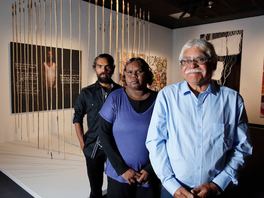 Frank Young, Anwar Young and Unrupa Rhonda Dick stand in front of their award-winning artwork.