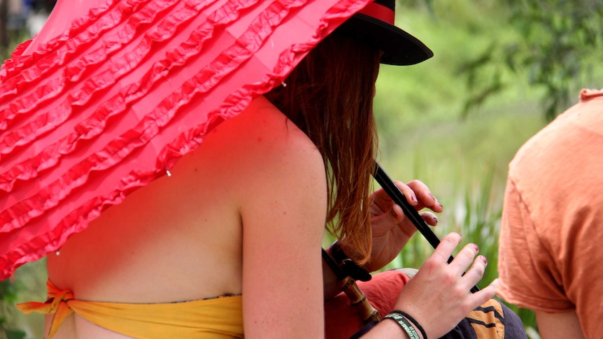 A woman plays the flute at the Woodford Folk Festival.