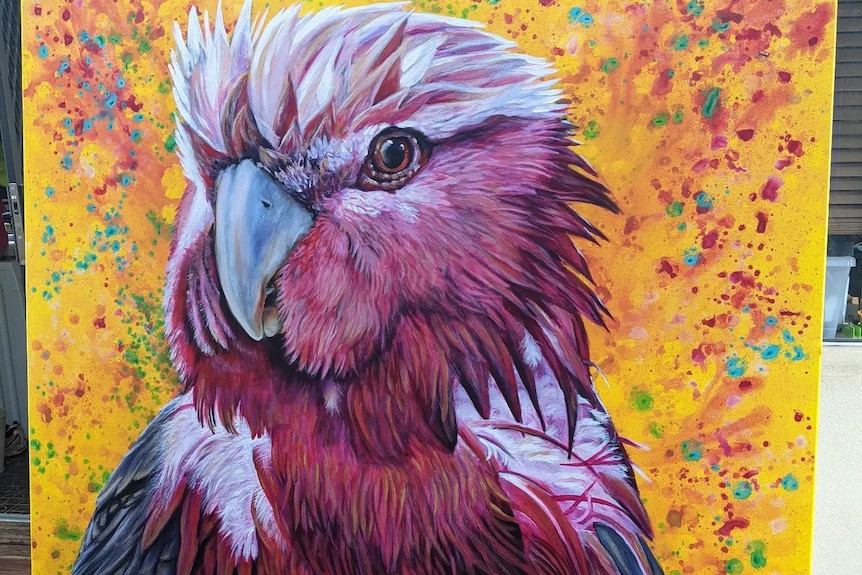 A large painting of a pink and white galah on a yellow background