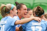 Melbourne City players hug each other as they celebrate a goal in the W-League grand final.