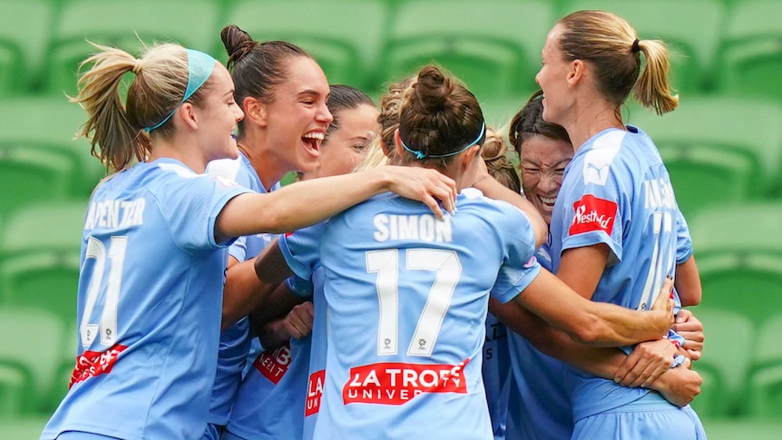 Melbourne City players hug each other as they celebrate a goal in the W-League grand final.