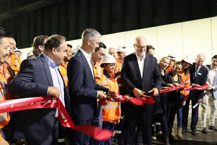 nsw minister fort roads john graham and other official cut a red ribbon to mark the opening of the rozelle interchange
