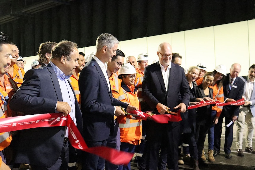 nsw minister fort roads john graham and other official cut a red ribbon to mark the opening of the rozelle interchange