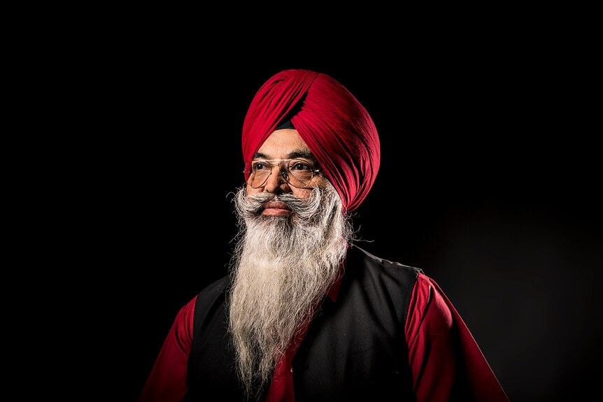 An elderly Sikh man, Darshan Singh Sidhu, wears a maroon-coloured turban and glasses.