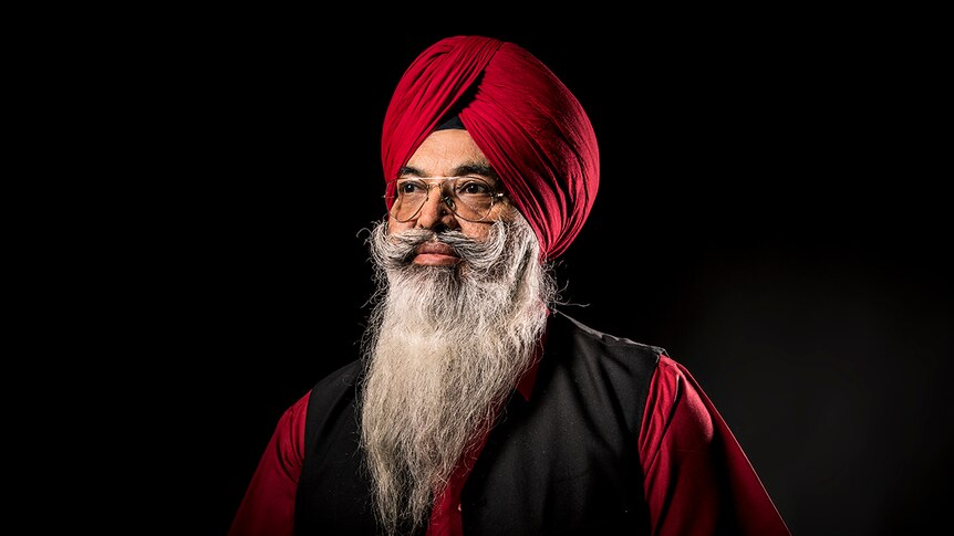 An elderly Sikh man, Darshan Singh Sidhu, wears a maroon-coloured turban and glasses.