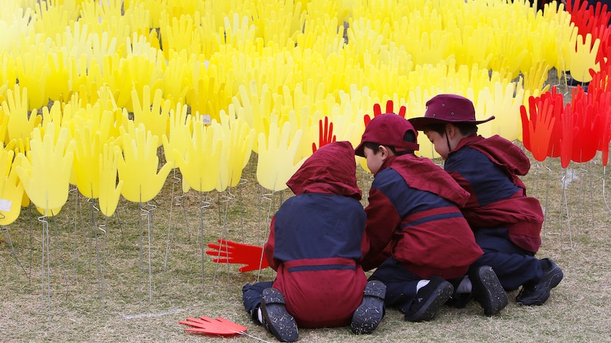 Students plant hands at the Barangaroo Sea Of Hands exhibition