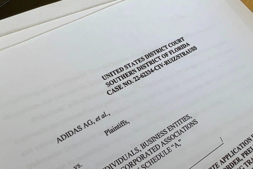 A printed legal document from the US district court in Florida, listing Adidas and others as plaintiffs.