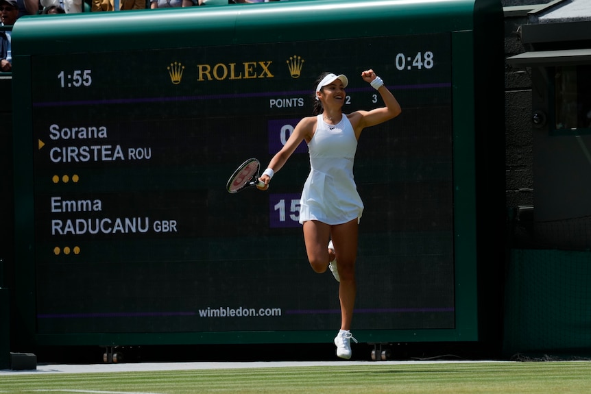 A British tennis player leaps off the ground after winning a key point in her match at Wimbledon.