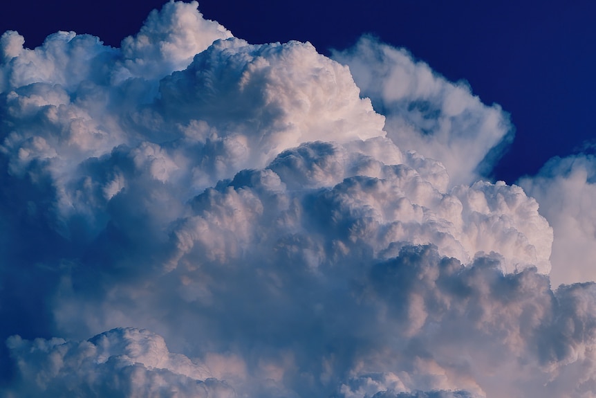 An intense cloud builds rising into the sky