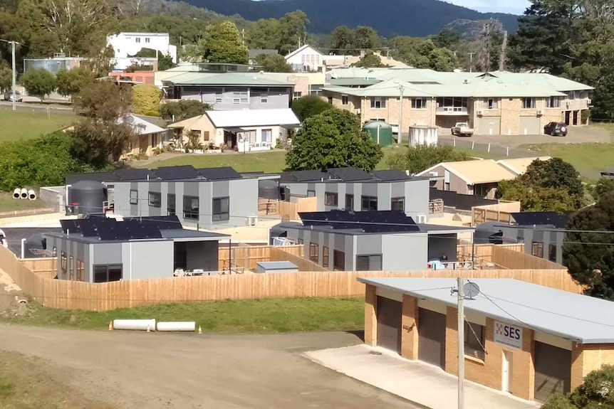 Five modern public housing units fitting out with solar panels on their roofs. 