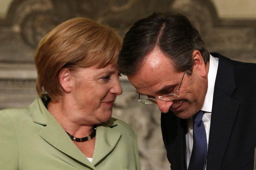 Greek PM Samaras listens to German chancellor Merkel