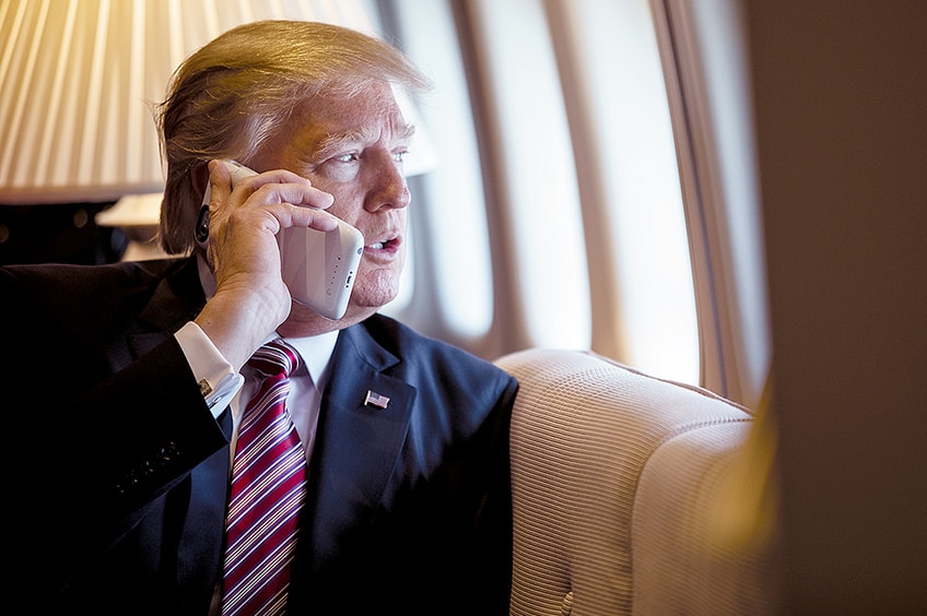 US President Donald Trump talks on the phone aboard Air Force One.