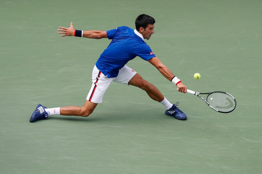 Novak Djokovic stretches for a shot at the US Open