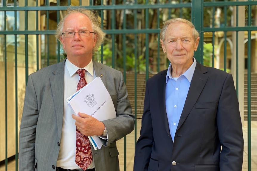 david and marshall in suits outside parliament.