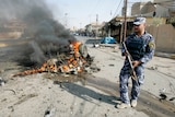 Policeman stands guard at Iraq blast site