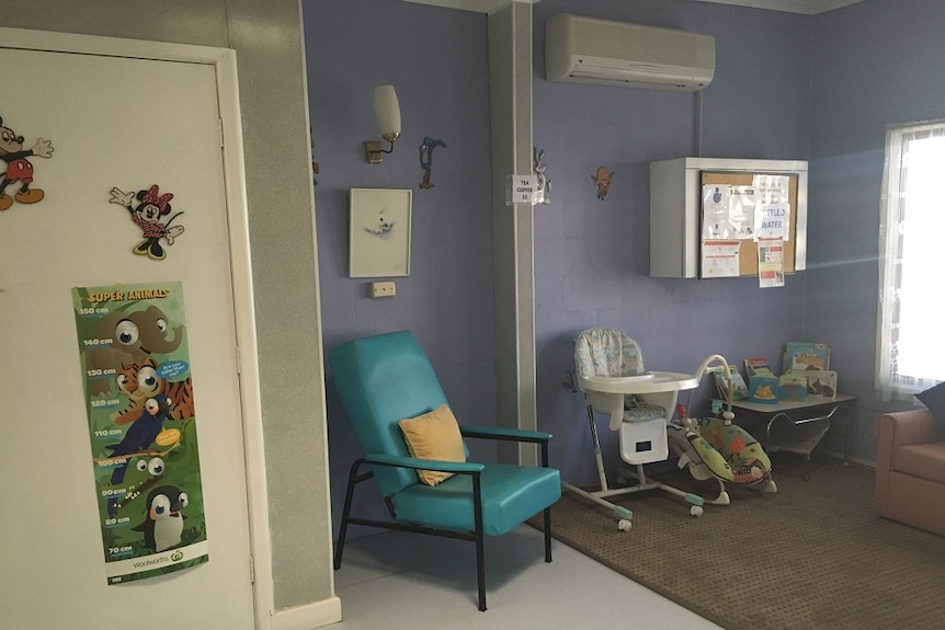 Nursery with heigh chart on the wall, high chair, rocker and couches